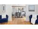 Open dining area with modern chandelier, white table and grey chairs, with hardwood flooring at 1915 10Th N St, St Petersburg, FL 33704