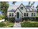 Charming home with a green door, complemented by lush landscaping and a well-manicured lawn at 1915 10Th N St, St Petersburg, FL 33704
