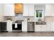 Updated kitchen with stainless steel appliances, white cabinets, and view of an outside garden at 1915 10Th N St, St Petersburg, FL 33704