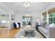 Bright living room featuring a decorative rug, neutral-toned sofa with pillows, and natural light at 1915 10Th N St, St Petersburg, FL 33704