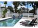 Inviting in-ground pool with sun loungers, perfect for relaxation and outdoor enjoyment at 1915 10Th N St, St Petersburg, FL 33704