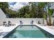 Sparkling in-ground pool surrounded by lounge chairs and lush landscaping at 1915 10Th N St, St Petersburg, FL 33704