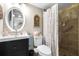 Cozy bathroom featuring a vanity with dark wood cabinets and a shower with flamingo-themed decor at 2060 Marilyn St # 114, Clearwater, FL 33765