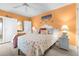 Bright bedroom with white furniture, shell-themed bedding, and a coastal-inspired design at 2060 Marilyn St # 114, Clearwater, FL 33765
