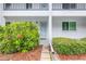 Charming condo entrance with a well-kept garden and a path leading to the front door at 2060 Marilyn St # 114, Clearwater, FL 33765
