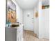 Light and bright condo hallway decorated with beach-themed art and decor at 2060 Marilyn St # 114, Clearwater, FL 33765