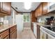 Functional kitchen with white appliances, wood cabinets, and ample counter space provides convenience for meal preparation at 2060 Marilyn St # 114, Clearwater, FL 33765