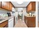 Efficient kitchen with wood cabinets, white appliances, and adjacent dining area ensures ease of cooking and entertaining at 2060 Marilyn St # 114, Clearwater, FL 33765