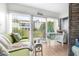 Bright living room with patio access offers seamless indoor-outdoor living with a comfortable seating area and desk at 2060 Marilyn St # 114, Clearwater, FL 33765
