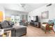 Well-lit condo living room with a stylish TV and light wood floors at 2060 Marilyn St # 114, Clearwater, FL 33765
