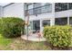 Outdoor patio with table, chairs, decorative flamingo statues, and lush greenery at 2060 Marilyn St # 114, Clearwater, FL 33765