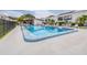 Community pool with surrounding lounge chairs and a covered poolside structure at 2060 Marilyn St # 114, Clearwater, FL 33765