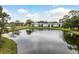 Aerial view of the rear exterior of the condo building with lake and mature trees at 210 Martha Ln # 210, Oldsmar, FL 34677