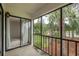 Balcony overlooking a pond with tropical plants and furnishings with direct access to the unit's interior at 210 Martha Ln # 210, Oldsmar, FL 34677