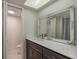Well lit bathroom featuring an ornately framed mirror, modern fixtures, and neutral color palette at 210 Martha Ln # 210, Oldsmar, FL 34677