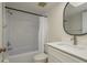 Bathroom with white vanity, modern faucet, round mirror, and shower/tub combo with white curtain at 210 Martha Ln # 210, Oldsmar, FL 34677