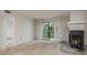 Inviting living room with fireplace and a sliding glass door leading to a balcony with scenic outdoor views at 210 Martha Ln # 210, Oldsmar, FL 34677