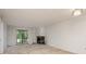 Bright living room featuring a fireplace, a large window, and neutral-toned carpet creating a comfortable atmosphere at 210 Martha Ln # 210, Oldsmar, FL 34677