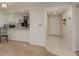 Cozy living space featuring a partial view of the kitchen and tile flooring leading to the front door at 210 Martha Ln # 210, Oldsmar, FL 34677