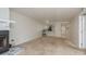 Open living room with a stone fireplace and access to the kitchen, creating a welcoming and functional living space at 210 Martha Ln # 210, Oldsmar, FL 34677
