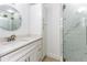 This bathroom offers a shower with glass door, large vanity, and lots of storage at 241 Skiff Pt # 1, Clearwater Beach, FL 33767