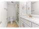 Bathroom boasts updated vanity, granite counters, a walk-in shower with glass, and tile floors at 241 Skiff Pt # 1, Clearwater Beach, FL 33767