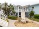 Charming coastal-style building featuring a landscaped entrance with stone accents and well-maintained exterior with stairs at 241 Skiff Pt # 1, Clearwater Beach, FL 33767