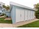 Exterior doors to storage with lush landscaping at 241 Skiff Pt # 1, Clearwater Beach, FL 33767