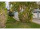 Exterior view of garage doors and mature landscaping at 241 Skiff Pt # 1, Clearwater Beach, FL 33767