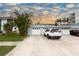 Charming townhome with an attached garage, private driveway and lush tropical landscaping at 241 Skiff Pt # 1, Clearwater Beach, FL 33767