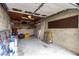 Spacious attached garage with concrete block walls, shelving, and overhead lighting at 241 Skiff Pt # 1, Clearwater Beach, FL 33767