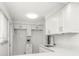 Bright kitchen features white cabinets, quartz countertops, tile backsplash, and stainless-steel faucet at 241 Skiff Pt # 1, Clearwater Beach, FL 33767