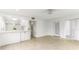 Open-concept living area with tile flooring, white walls, seamlessly connecting to the kitchen, and bright, airy feel at 241 Skiff Pt # 1, Clearwater Beach, FL 33767