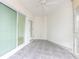 Spacious sunroom with a sliding glass door leading to the outside, tiled floors, and bright interior at 241 Skiff Pt # 1, Clearwater Beach, FL 33767