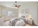 Cozy bedroom with a queen-size bed, soft lighting, and a ceiling fan at 25729 Aldus Dr, Land O Lakes, FL 34639