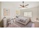 Sunlit bedroom with a twin bed, desk, and playful decor at 25729 Aldus Dr, Land O Lakes, FL 34639
