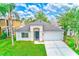 Beautiful single-story home featuring a well-kept lawn, a two-car garage, and a stylish arched entryway at 25729 Aldus Dr, Land O Lakes, FL 34639