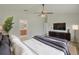 An open main bedroom with a large bed and a view into the ensuite bathroom at 25729 Aldus Dr, Land O Lakes, FL 34639