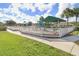 A community playground with a safety fence, features various play structures, and has a covered picnic area at 25729 Aldus Dr, Land O Lakes, FL 34639