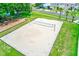 A well-maintained sand volleyball court is surrounded by a lush green lawn and a playground at 25729 Aldus Dr, Land O Lakes, FL 34639