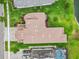 Aerial view of the home displaying the roof, driveway, nearby pool, and manicured lawn at 2724 Coco Palm Cir, Wesley Chapel, FL 33543