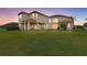 Expansive backyard featuring a covered patio, perfect for outdoor living and entertaining, plus plenty of green space at 2724 Coco Palm Cir, Wesley Chapel, FL 33543