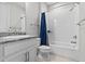 A full bathroom featuring a white shower, white tiled walls, and a granite sink at 2724 Coco Palm Cir, Wesley Chapel, FL 33543