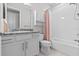 Clean bathroom featuring a mirror, shower, toilet and storage cabinet at 2724 Coco Palm Cir, Wesley Chapel, FL 33543