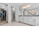 Bright bathroom featuring dual sinks, granite countertops, and a walk-in shower at 2724 Coco Palm Cir, Wesley Chapel, FL 33543