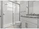 Bright bathroom with glass shower, granite countertop and white vanity at 2724 Coco Palm Cir, Wesley Chapel, FL 33543