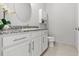 Half bathroom features a granite countertop, decorative mirror, and elegant faucet, adding a touch of luxury at 2724 Coco Palm Cir, Wesley Chapel, FL 33543
