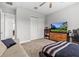 Comfortable bedroom with a large window, TV, and closet at 2724 Coco Palm Cir, Wesley Chapel, FL 33543