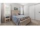 Cozy bedroom with a queen bed, coastal decor, and natural light streaming through the windows at 2724 Coco Palm Cir, Wesley Chapel, FL 33543
