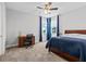 Comfortable bedroom with an oversized ceiling fan, large bed and two bright windows at 2724 Coco Palm Cir, Wesley Chapel, FL 33543